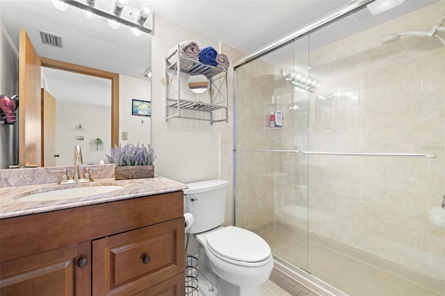 bathroom with toilet, vanity, and walk in shower