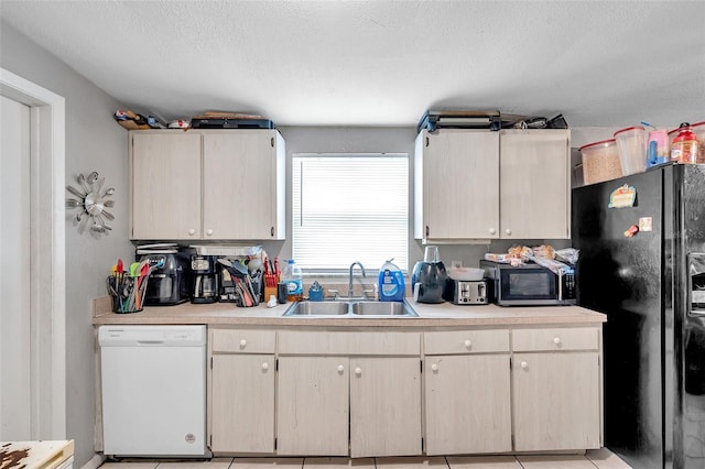 kitchen featuring white dishwasher, sink, black refrigerator with ice dispenser, and a textured ceiling