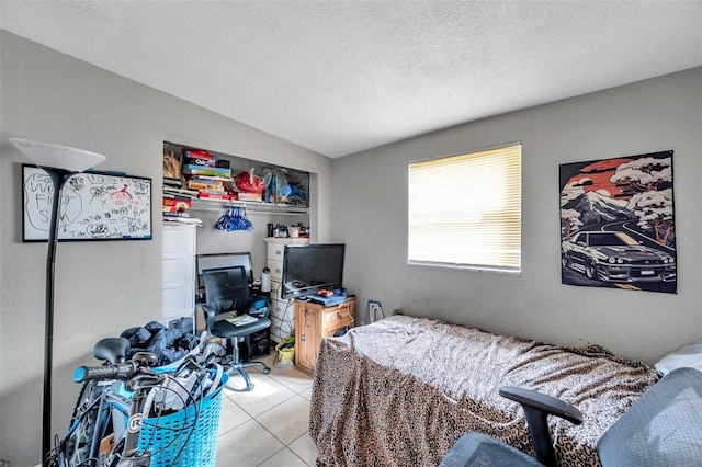 bedroom featuring vaulted ceiling, light tile patterned floors, and a textured ceiling