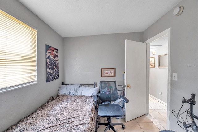 bedroom featuring light tile patterned flooring and a textured ceiling