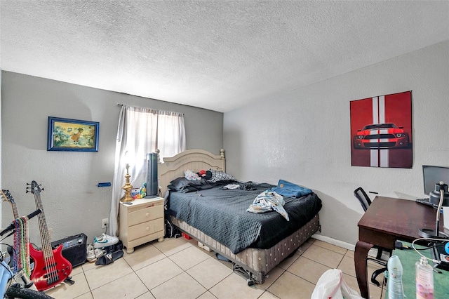 bedroom featuring light tile patterned floors and a textured ceiling