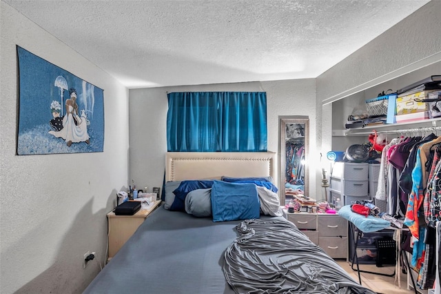 bedroom with a closet and a textured ceiling