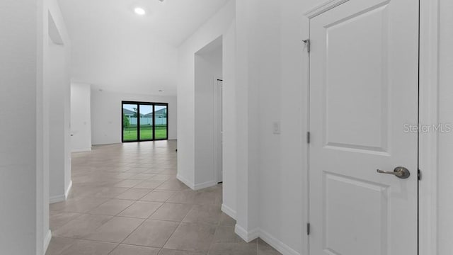 hall featuring light tile patterned floors