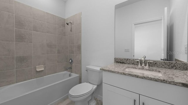 full bathroom with tiled shower / bath combo, vanity, and toilet