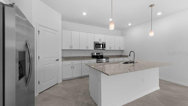 kitchen featuring pendant lighting, an island with sink, white cabinetry, sink, and stainless steel appliances