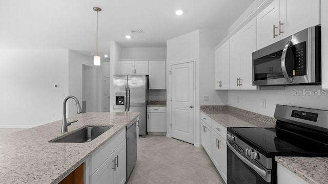 kitchen featuring pendant lighting, sink, stainless steel appliances, light stone countertops, and white cabinets