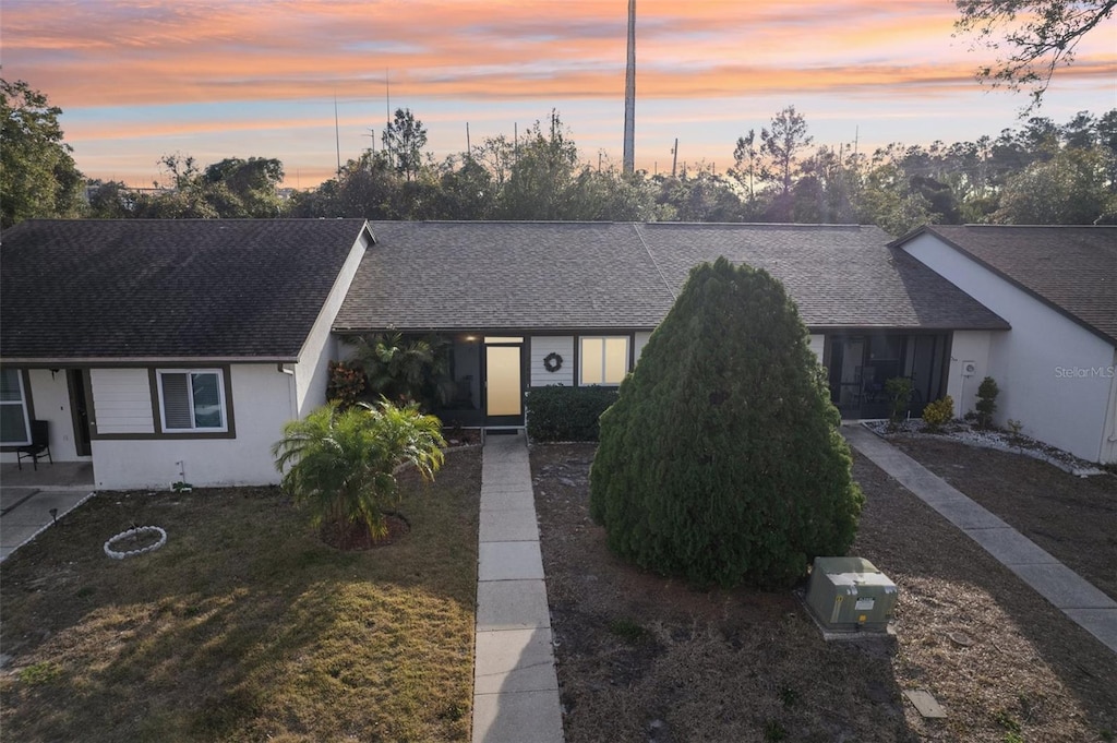 ranch-style house featuring a lawn