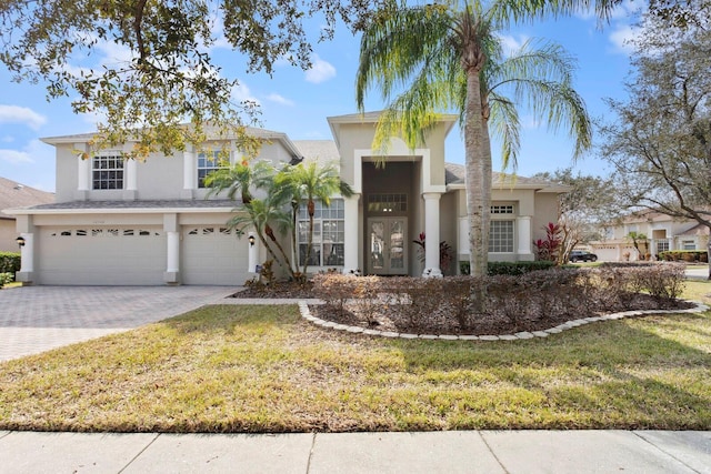 view of front of home featuring a garage and a front lawn