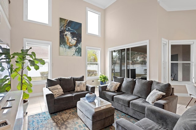 living room featuring a high ceiling, crown molding, plenty of natural light, and light tile patterned floors