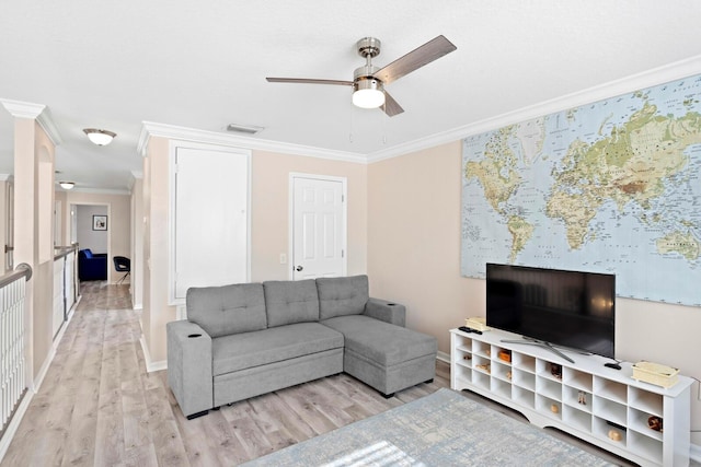 living room featuring ornamental molding, light hardwood / wood-style floors, and ceiling fan