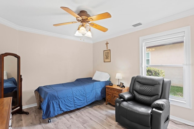 bedroom with crown molding, ceiling fan, and light hardwood / wood-style floors