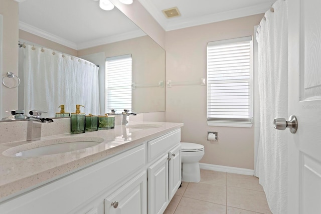 bathroom with tile patterned flooring, ornamental molding, a healthy amount of sunlight, and vanity