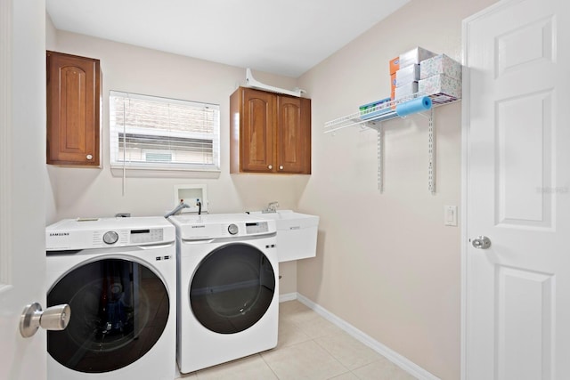 laundry room with separate washer and dryer, light tile patterned floors, sink, and cabinets