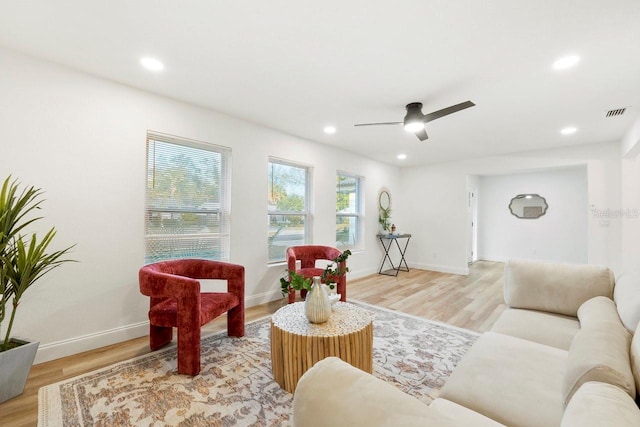 living room featuring ceiling fan and light wood-type flooring