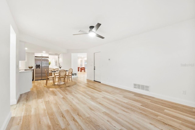 living room with ceiling fan and light wood-type flooring