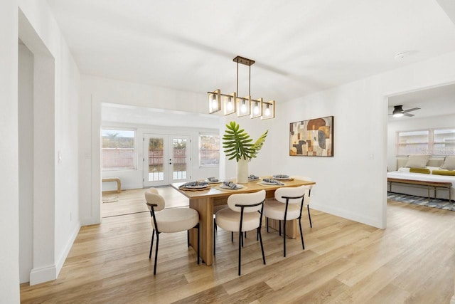 dining room with french doors and light wood-type flooring