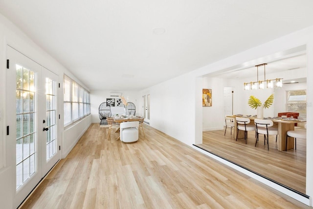 sitting room featuring light wood-type flooring and french doors