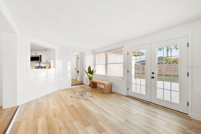 entryway with french doors and light wood-type flooring