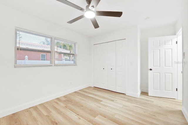 unfurnished bedroom with ceiling fan, light hardwood / wood-style floors, and a closet