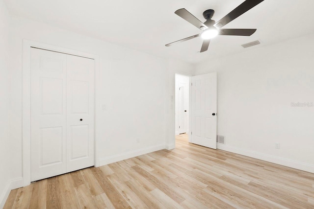 unfurnished bedroom with ceiling fan, light hardwood / wood-style floors, and a closet