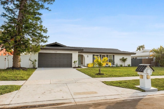 ranch-style home with a garage and a front lawn