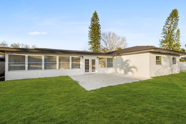 back of house with french doors, a yard, and a patio