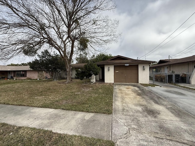 view of front of property featuring a garage and a front lawn