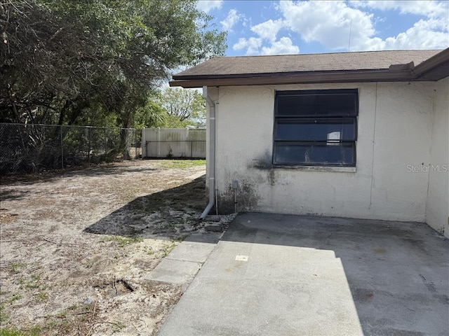 exterior space with fence and a patio