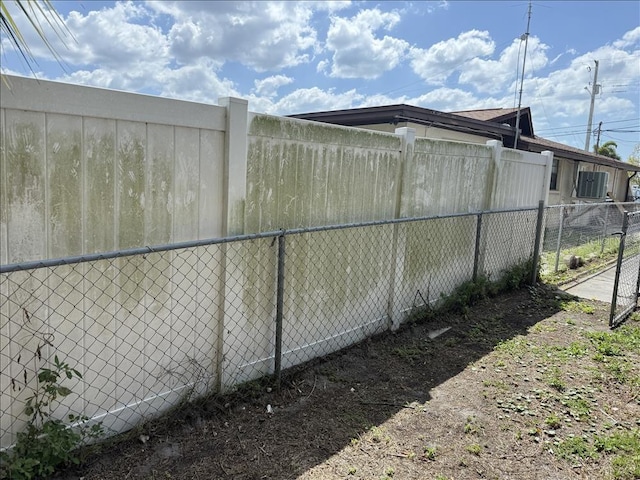 view of side of home featuring fence