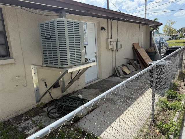 view of property exterior featuring stucco siding and fence
