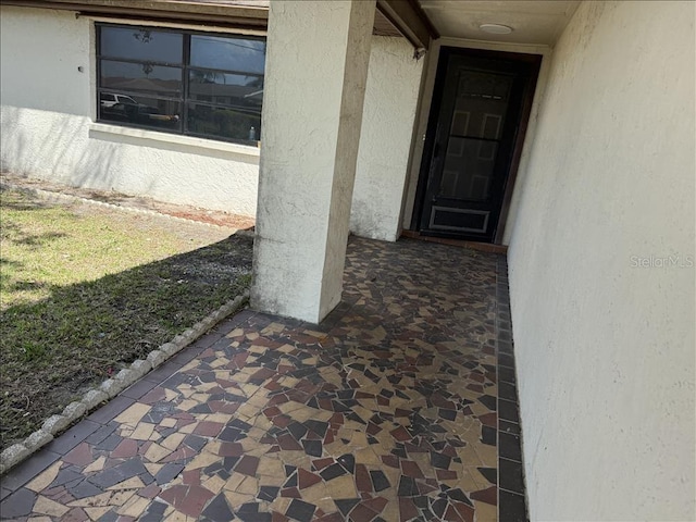 view of exterior entry with stucco siding