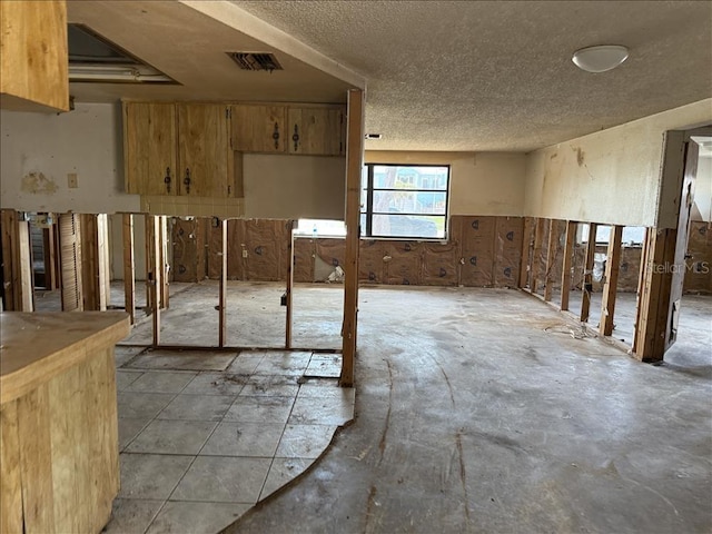 interior space featuring visible vents and a textured ceiling