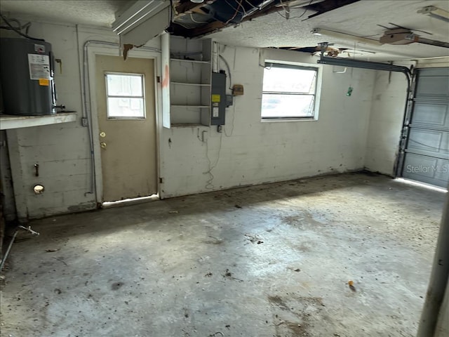 garage with electric panel, a garage door opener, and electric water heater