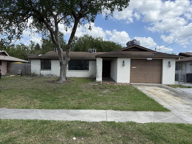 single story home featuring a front lawn, fence, a garage, and concrete driveway