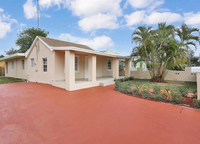 back of property with a patio