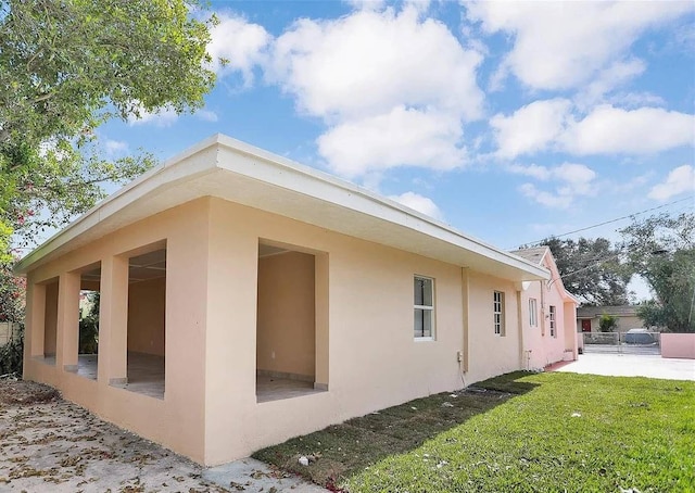 view of property exterior with a lawn