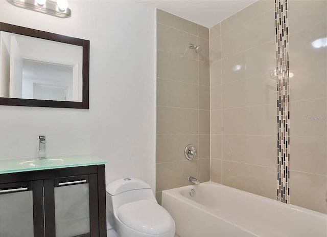 full bathroom with tiled shower / bath combo, vanity, and toilet