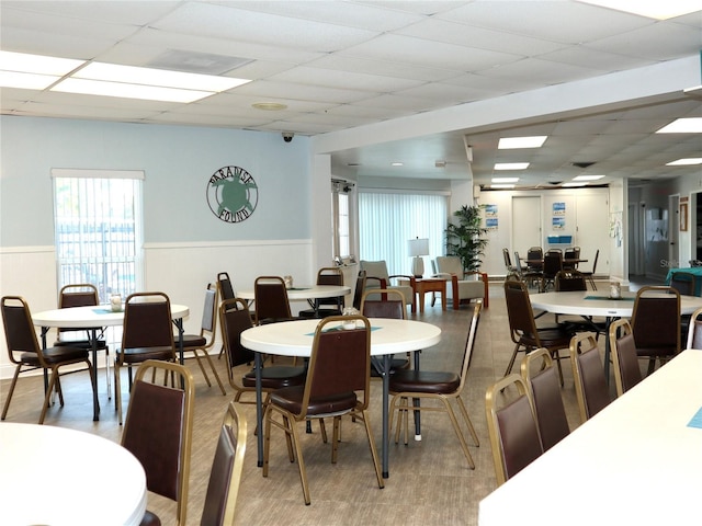 dining space featuring a drop ceiling