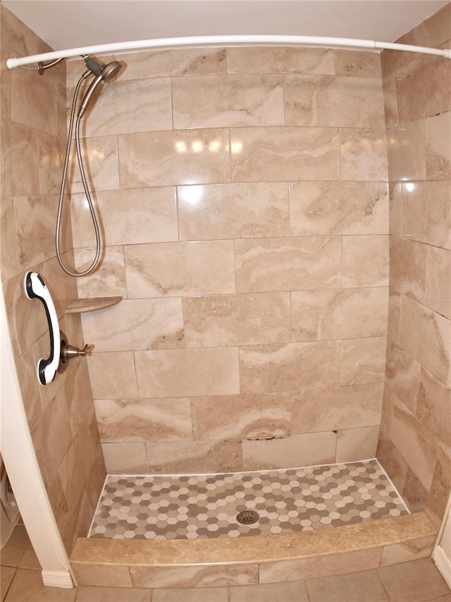 bathroom with tiled shower