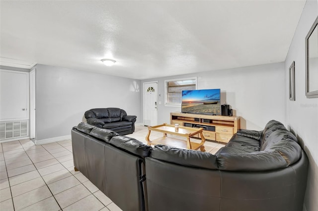 living room with a textured ceiling and light tile patterned flooring