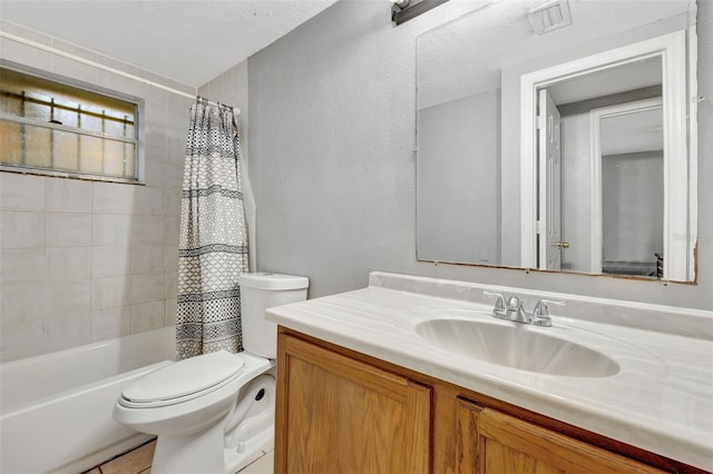 full bathroom with vanity, toilet, shower / bath combo with shower curtain, and a textured ceiling