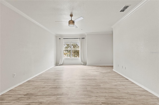 empty room featuring crown molding, a textured ceiling, ceiling fan, and light wood-type flooring