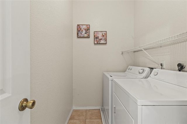 laundry room featuring light tile patterned flooring and washer and dryer