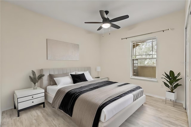 bedroom with ceiling fan and light hardwood / wood-style flooring