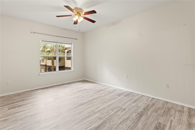 empty room featuring ceiling fan and light hardwood / wood-style flooring