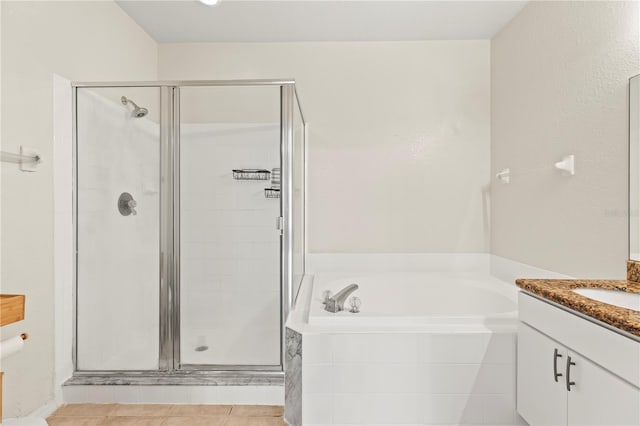 bathroom featuring vanity, independent shower and bath, and tile patterned flooring