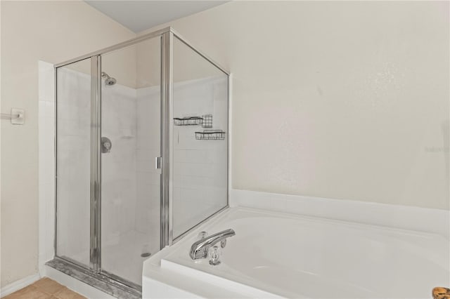 bathroom featuring shower with separate bathtub