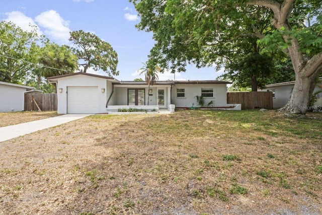 ranch-style house featuring a garage and a front yard