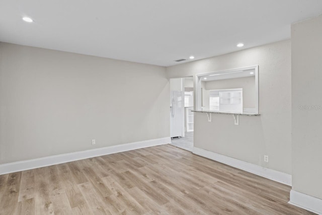 unfurnished room with light hardwood / wood-style flooring