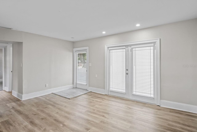 empty room with light hardwood / wood-style flooring